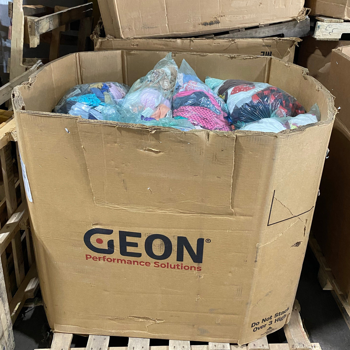Pallet box filled with mixed children's clothing
