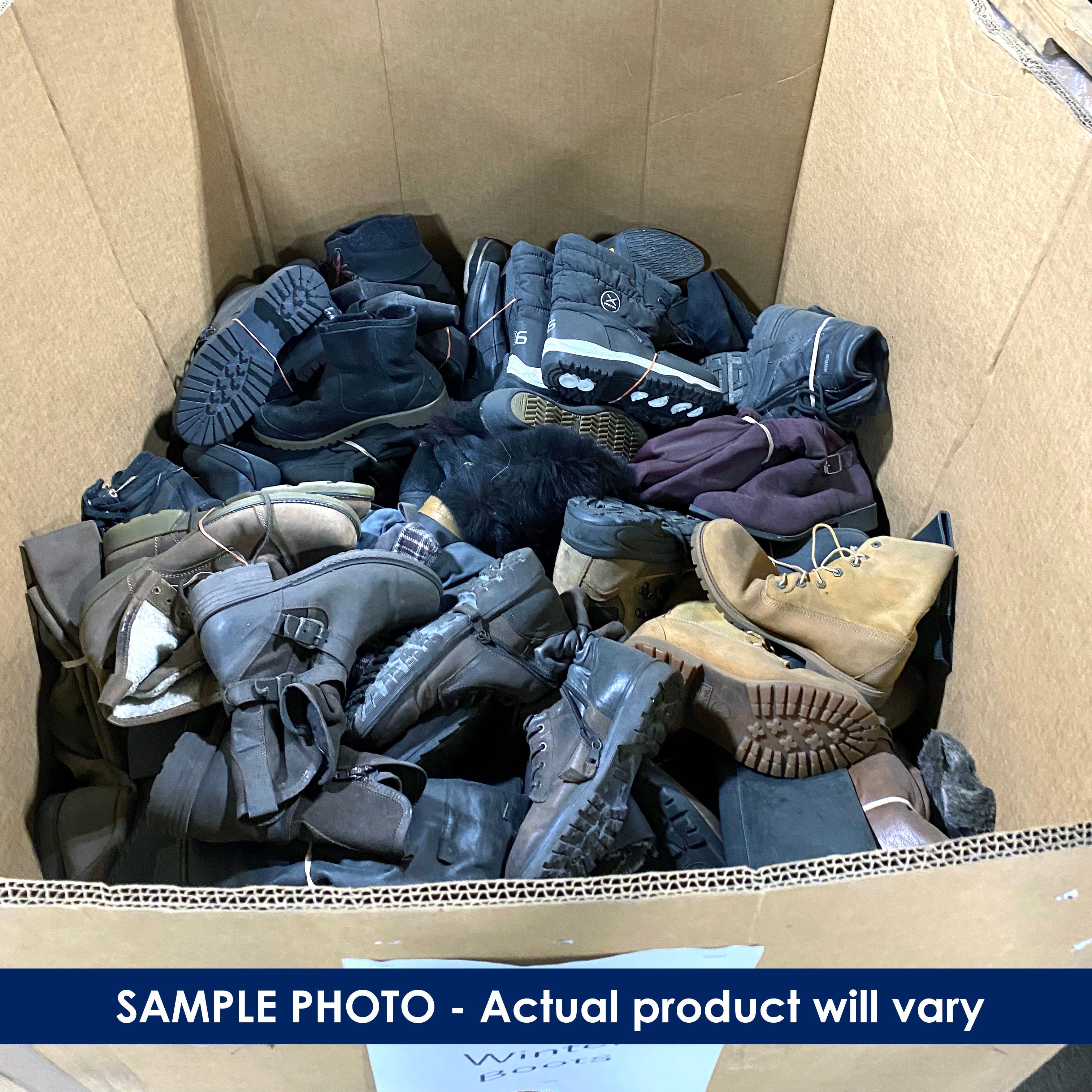 Pallet box filled with various pairs of boots and winter shoes.